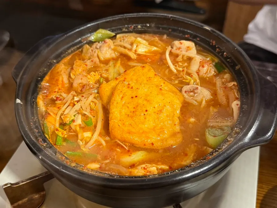 A bowl of gopchang hot pot with bean sprouts