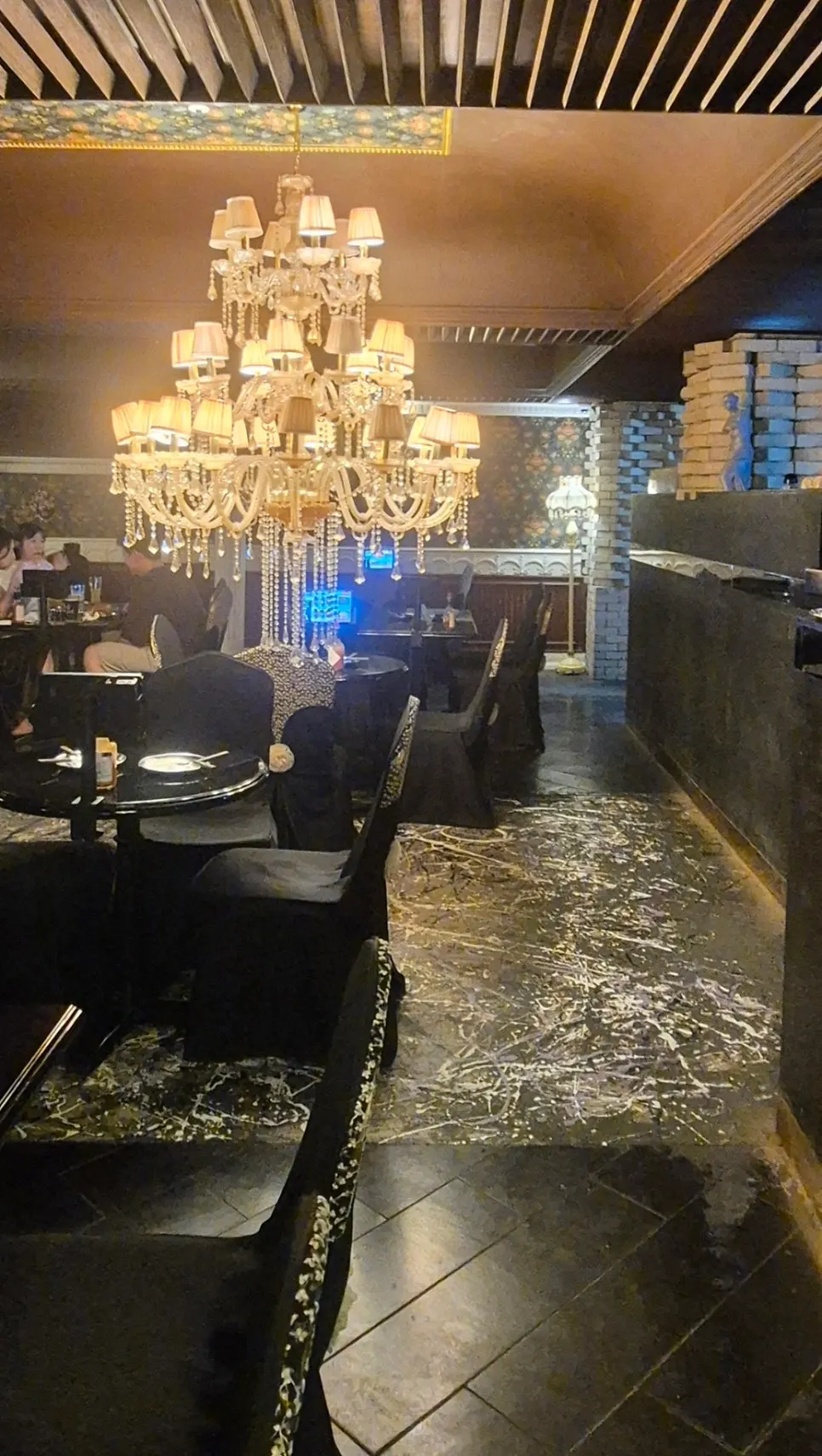 Ornate chandelier hanging from the ceiling of the restaurant