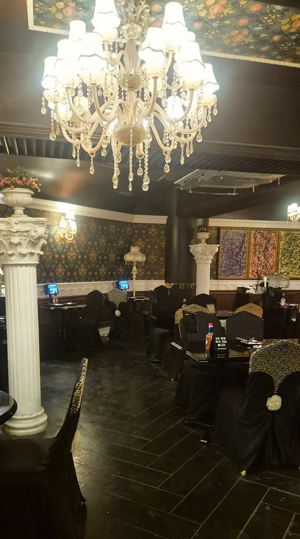 Corner of the restaurant with antique columns and furniture
