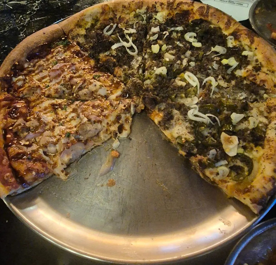 Full view of the half beef, half chicken pizza