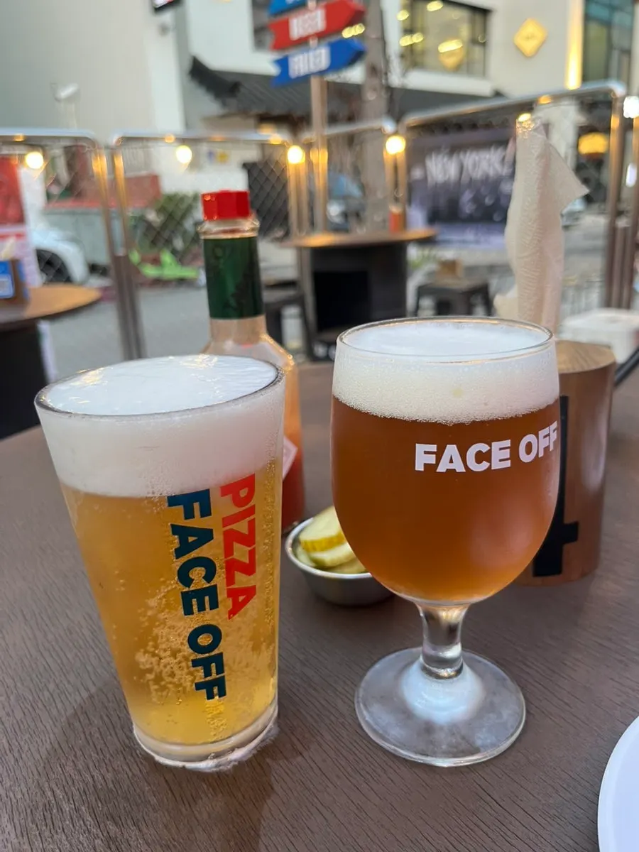 Two glasses of IPA and Cass draft beer served first