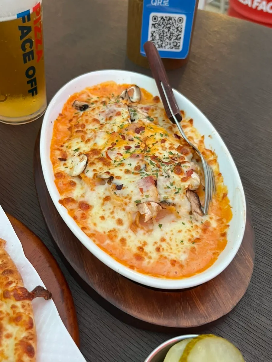 A slice of pizza with stretchy melted cheese