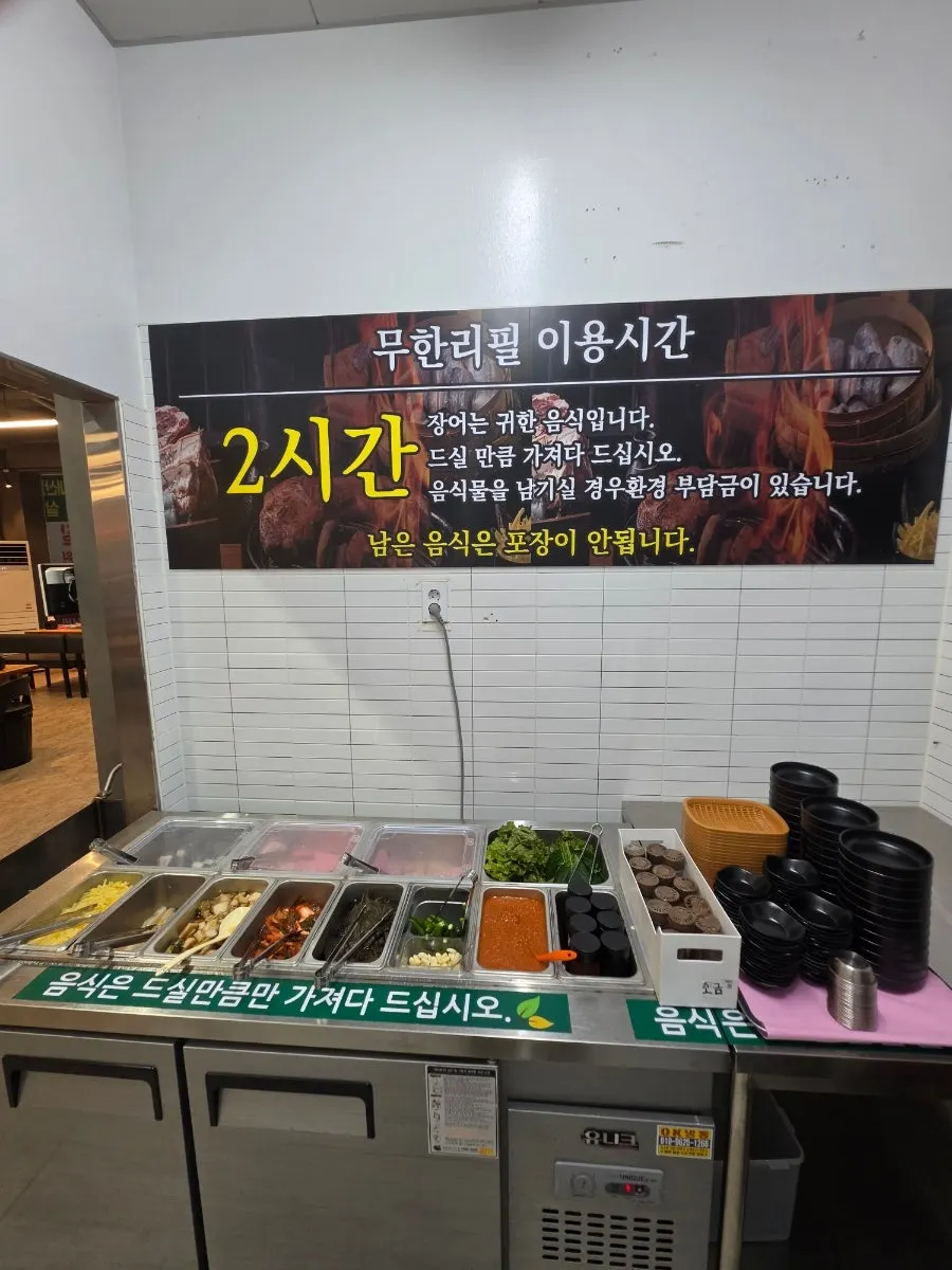 Filling a plate with side dishes at the self-serve bar