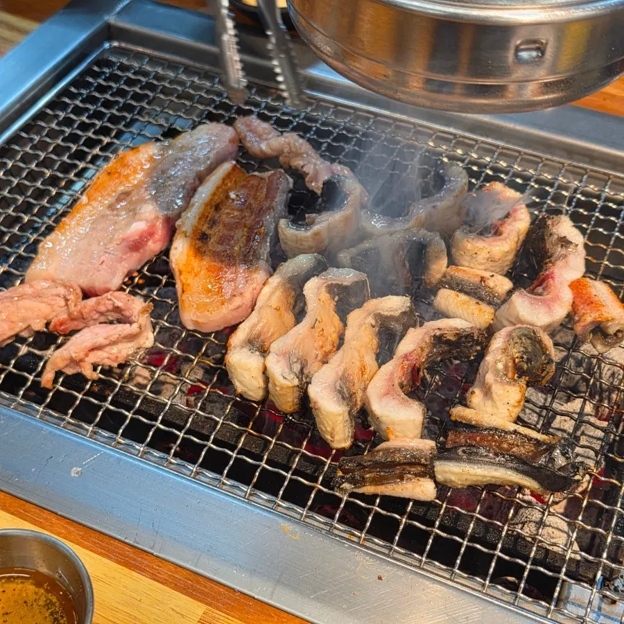 Freshwater eel placed skin-side down on the grill