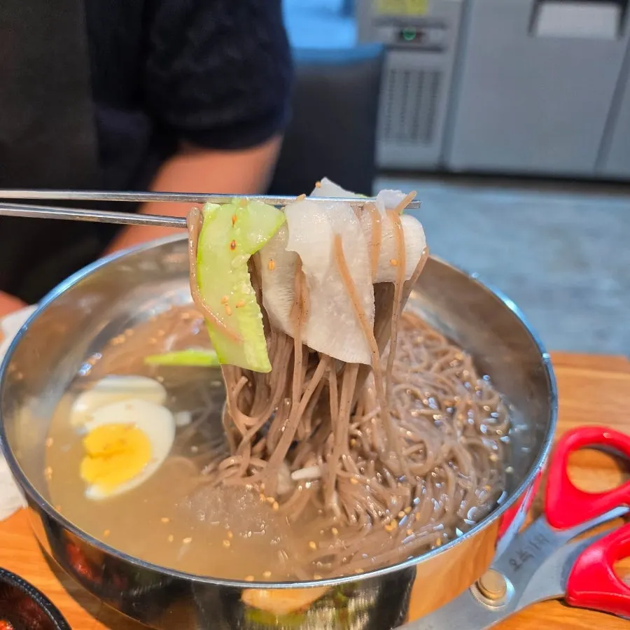 Cold noodles topped with cucumber and pickled radish