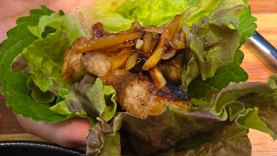 A lettuce wrap with eel, pork belly and ginger