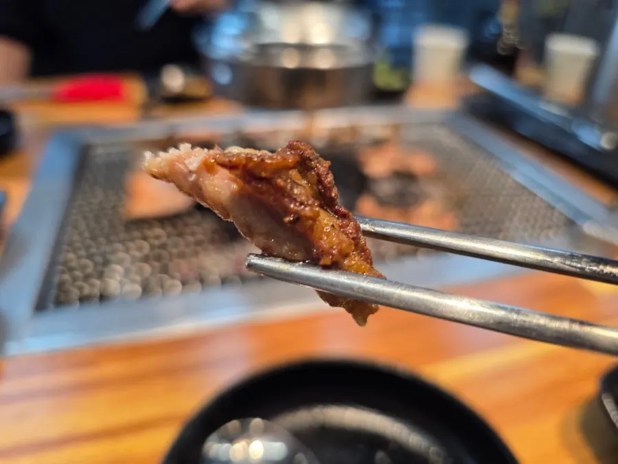 Duck neck grilling over charcoal
