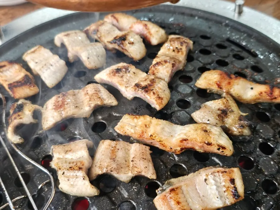Big chunks of freshwater eel freshly added to the grill