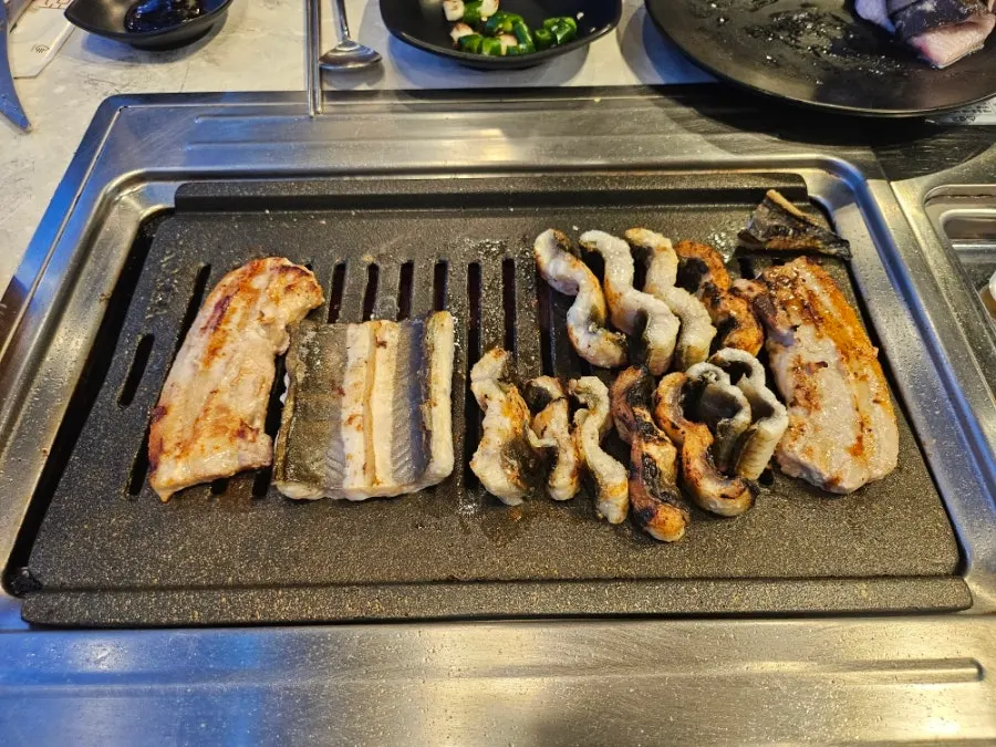 A full spread of grilled eel and side dishes