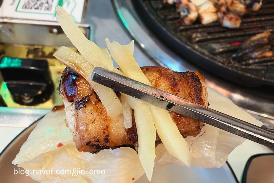 A piece of eel dipped in eel sauce