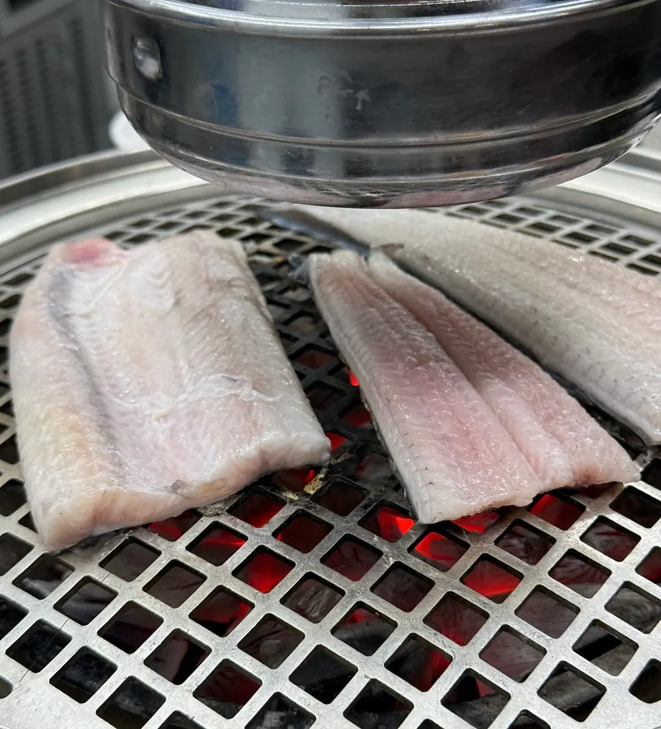 Raw freshwater eel placed on the charcoal grill