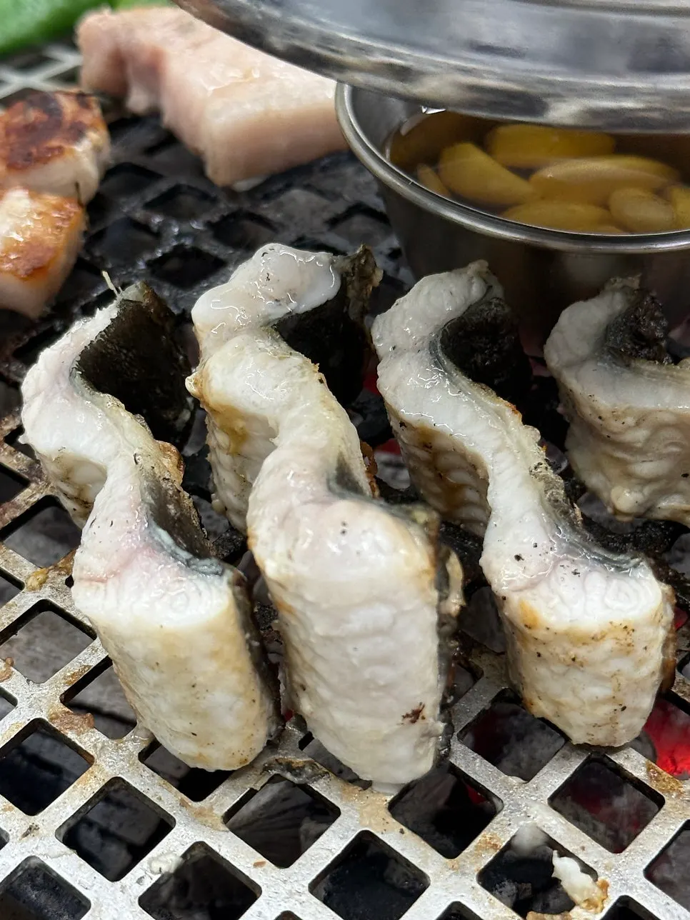 Eel cut into bite-sized pieces while grilling