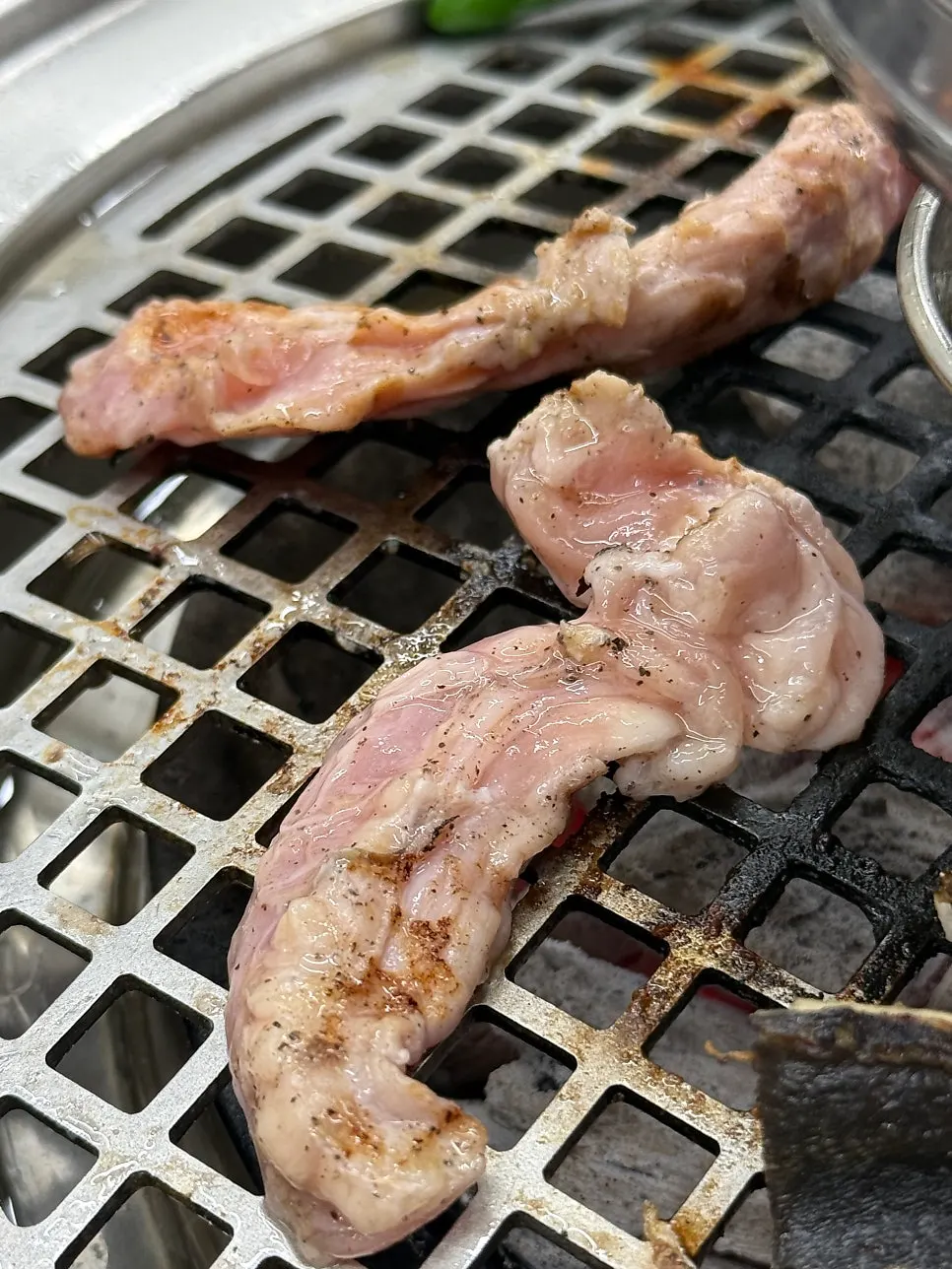 A grill full of eel and meat together