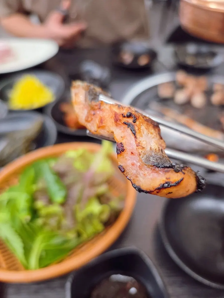 Thick eel cooking to a golden color on the grill