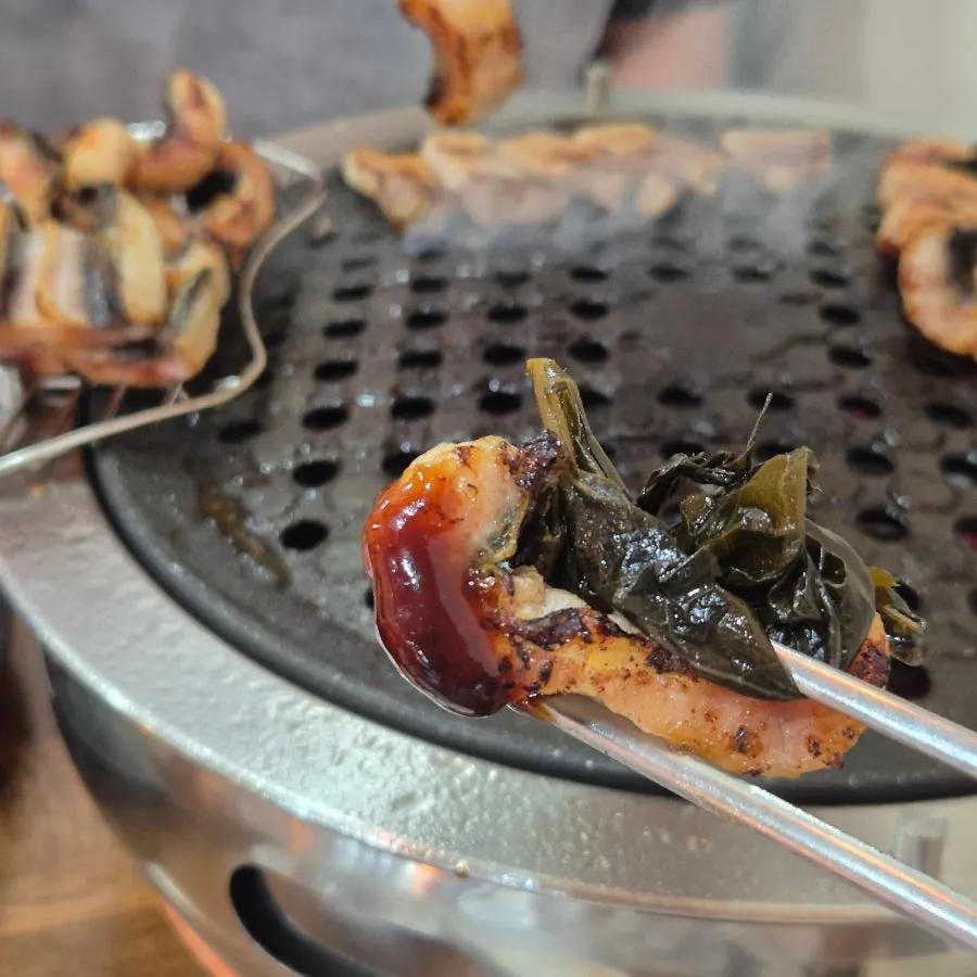 A piece of eel with sauce and julienned ginger