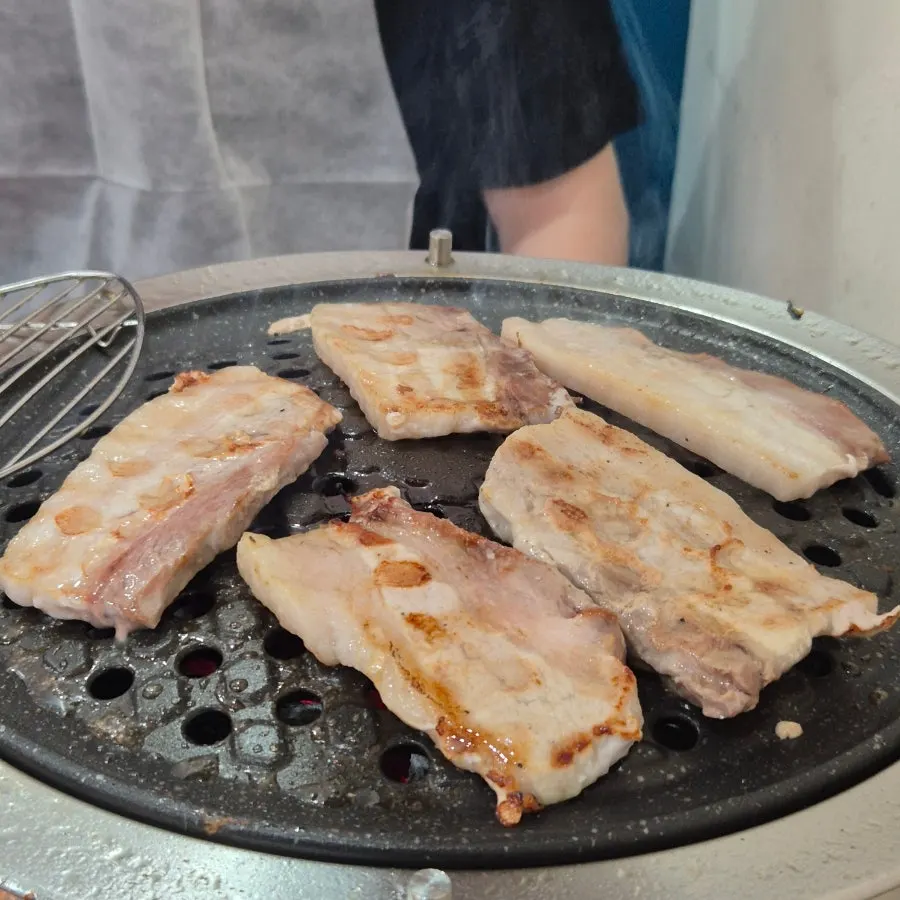 Danish pork belly cooking on the grill