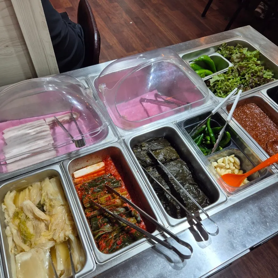 Self-serve bar with lettuce wraps, kimchi, and pickles