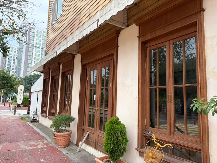 Café space with floor-to-ceiling windows and generously spaced tables