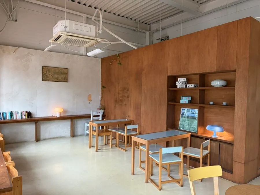 Café space with floor-to-ceiling windows and generously spaced tables