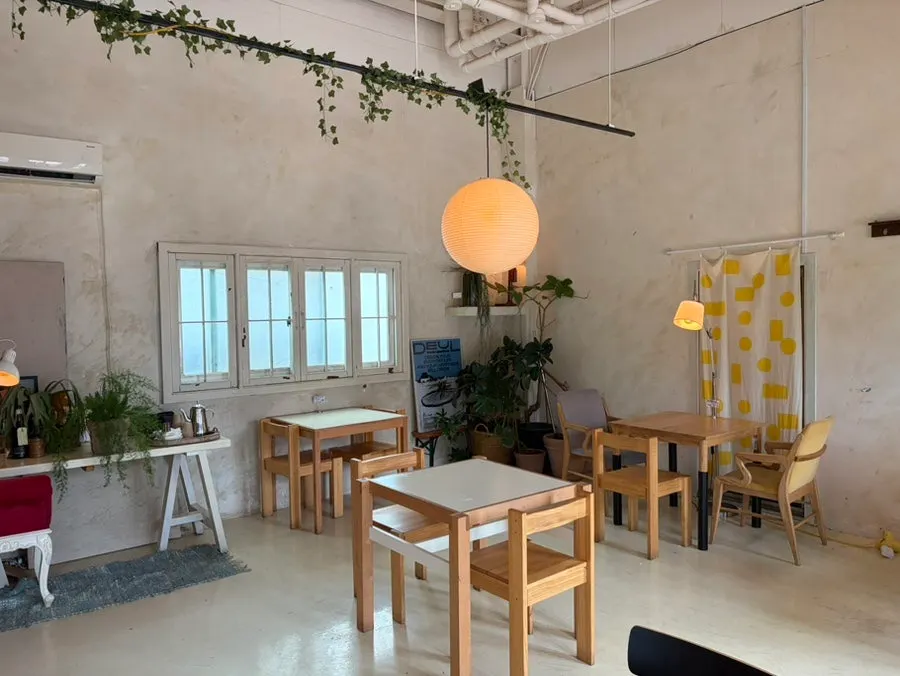 Café space with floor-to-ceiling windows and generously spaced tables