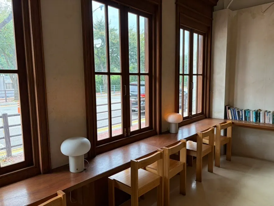 Café space with floor-to-ceiling windows and generously spaced tables