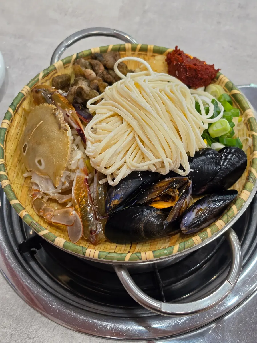 Seafood kalguksu tray piled with seafood