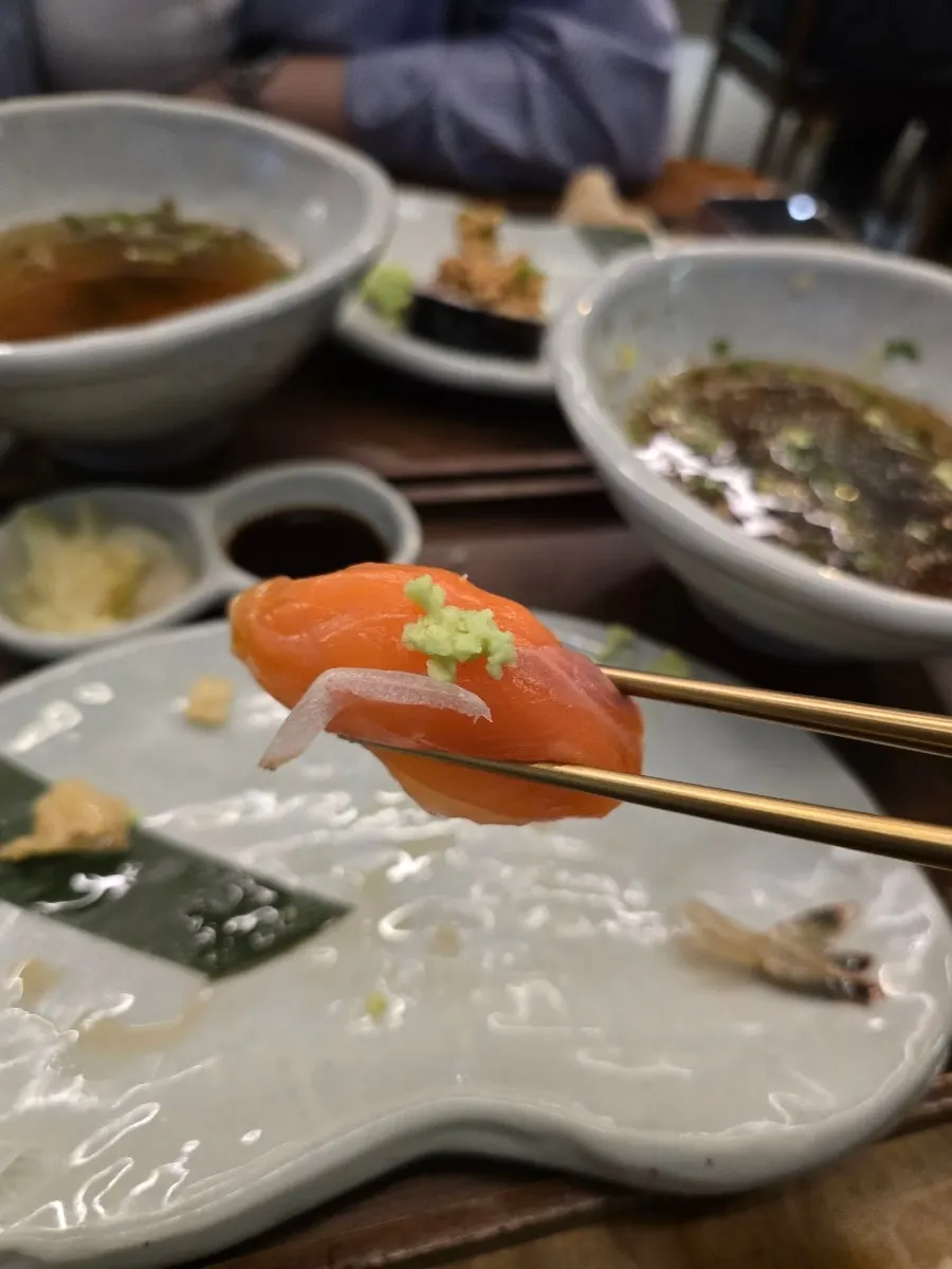 Close-up of egg nigiri held by hand