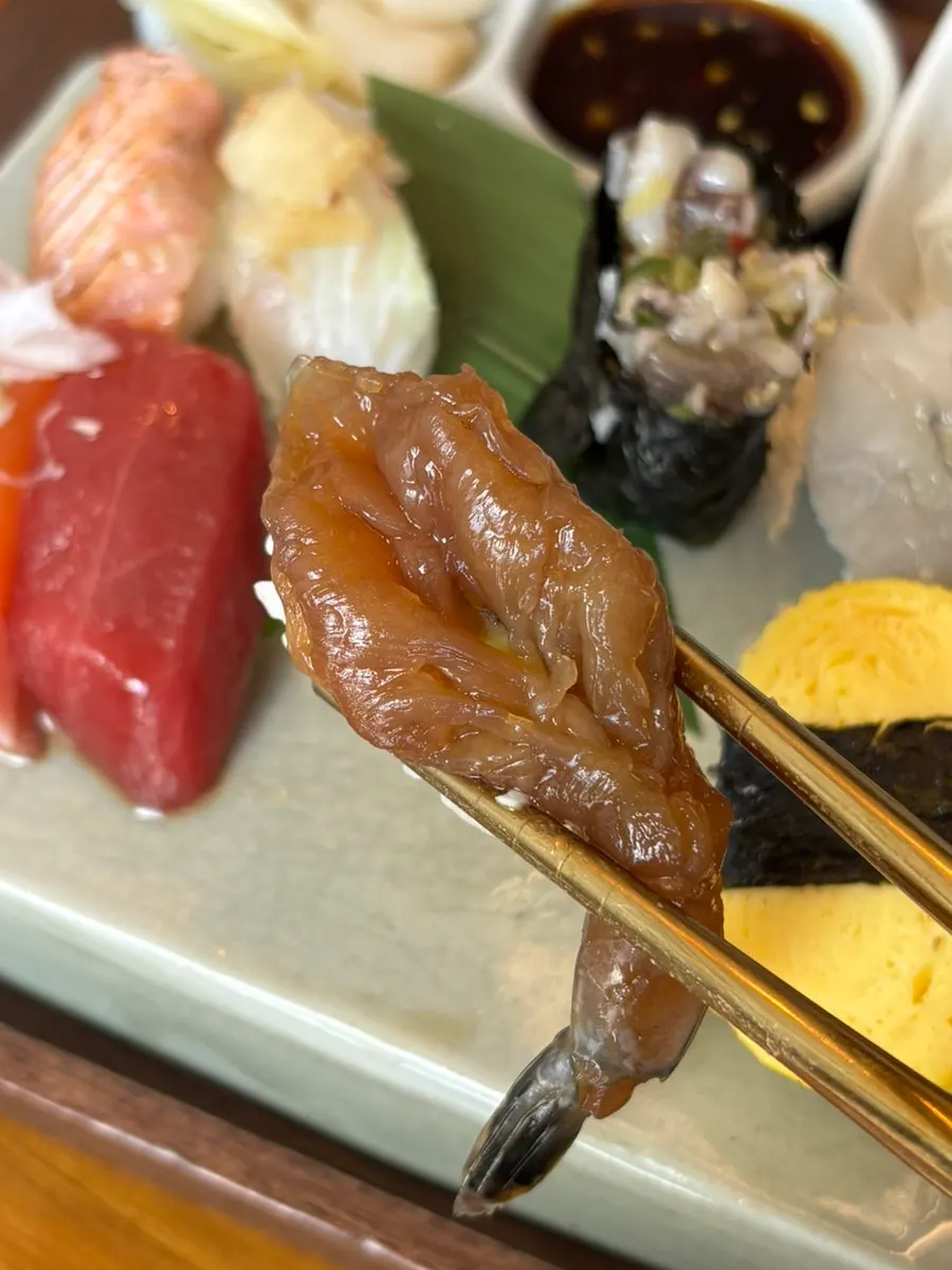 A plate of sushi with eel and gunkan rolls