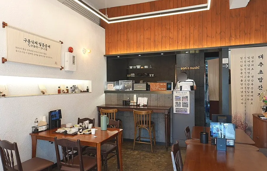 Interior of Sonsi Sushi in white and wood tones