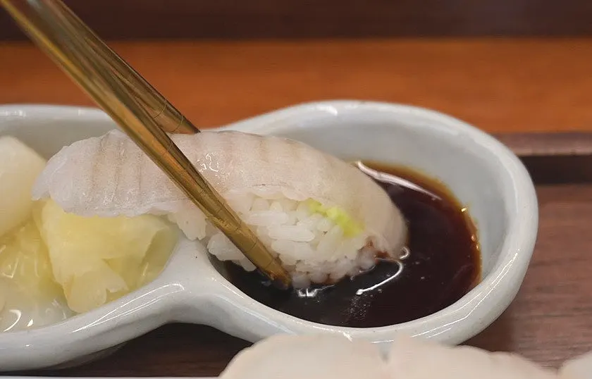 White fish sushi topped with aged sashimi