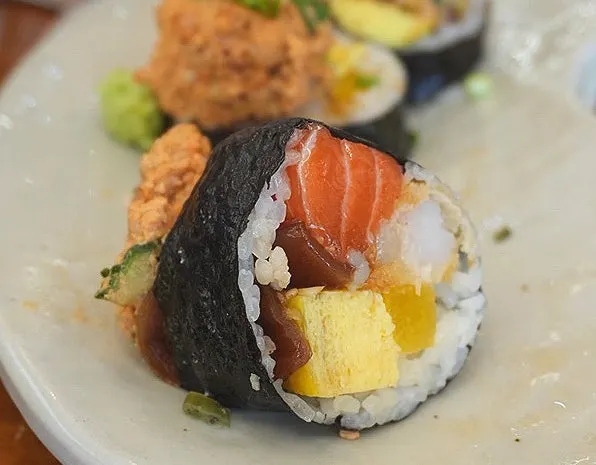 A thickly sliced piece of ankimo futomaki