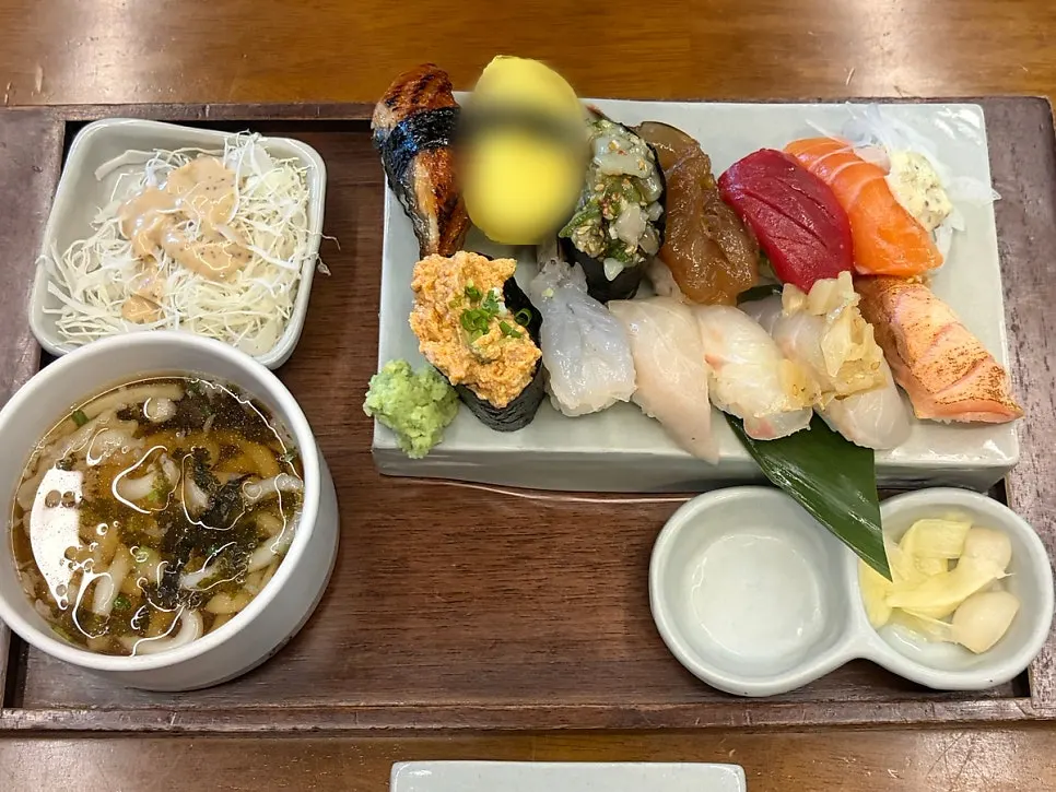 The premium aged nigiri arranged left to right for eating order