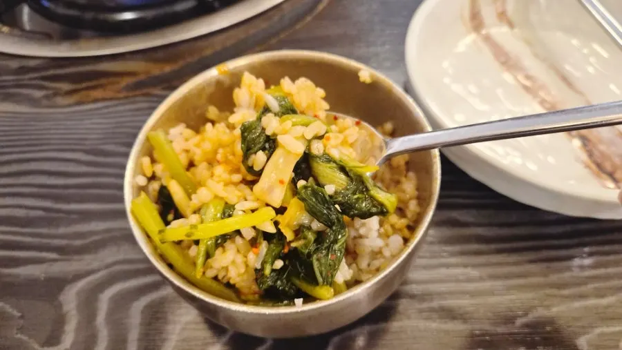 Table setting with barley rice, yeolmu kimchi, gochujang and sesame oil