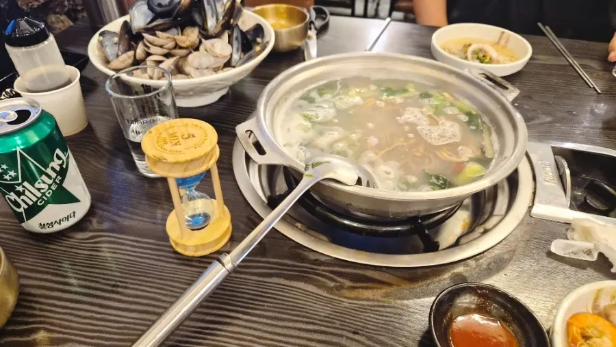 Hand-pulled acorn noodles added to the seafood broth