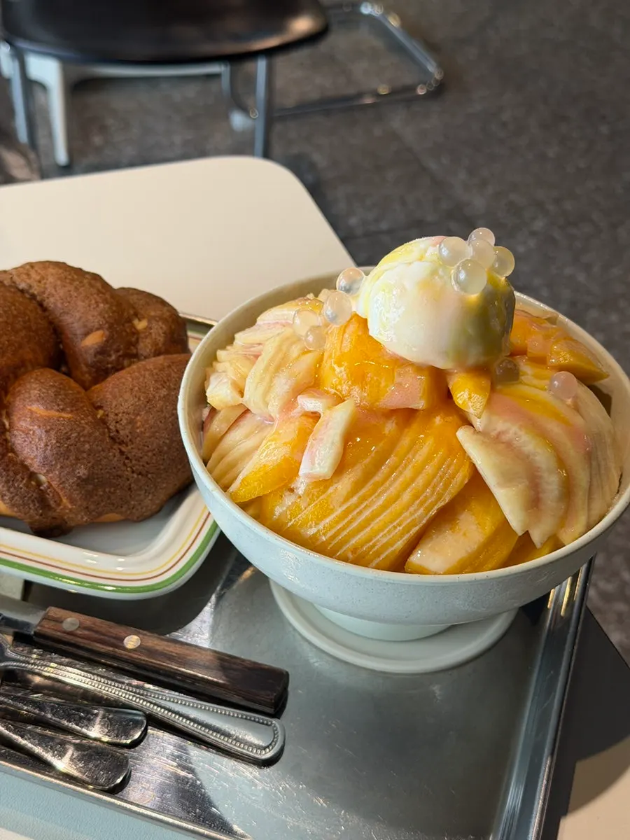 Close-up of peach bingsu topped with ice cream