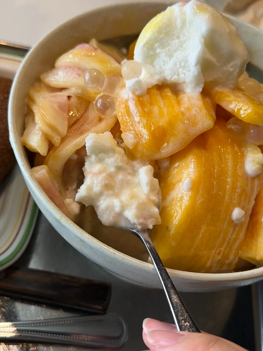 Cross-section of the peach bingsu showing the snow-fluffy ice