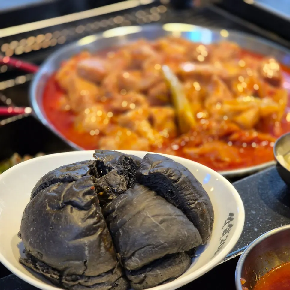 Squid ink bread served with the kimchi stew