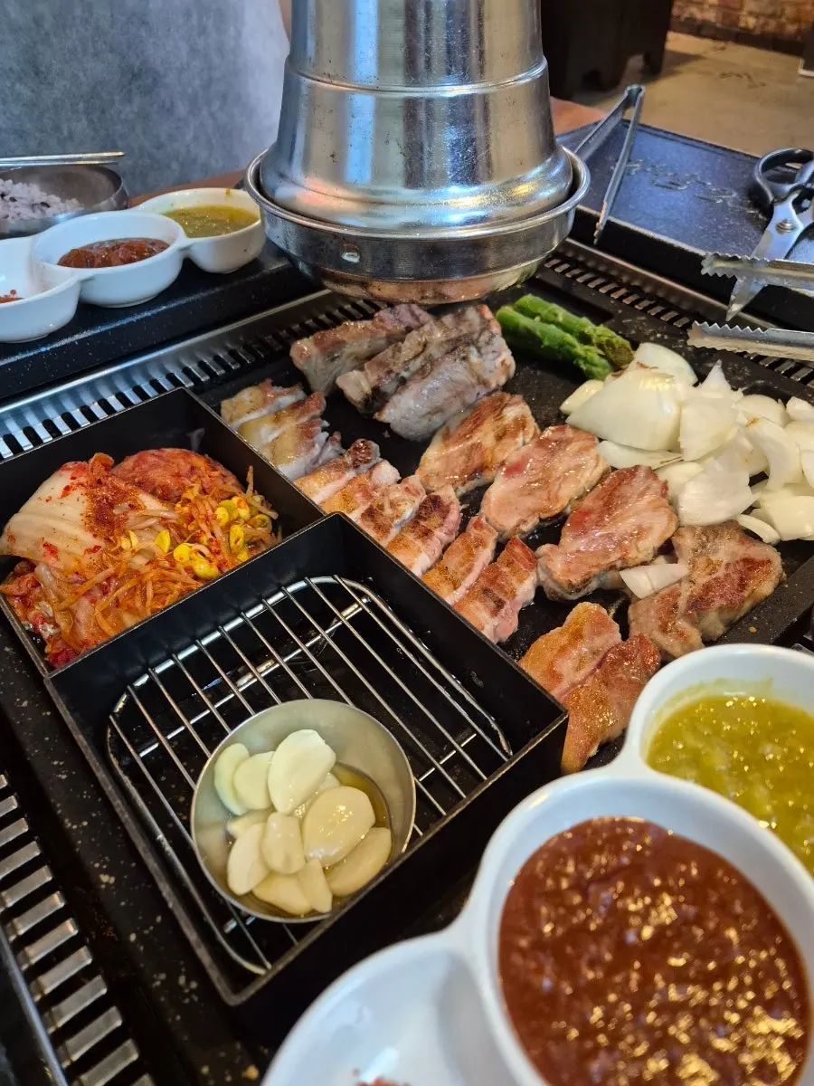 Meat turning golden brown with side vegetables