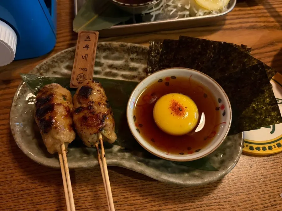 Eating tsukune wrapped in seaweed