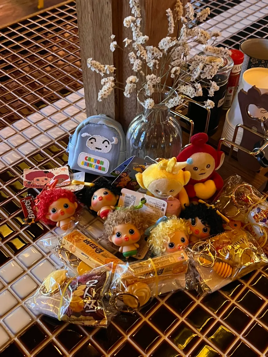 Dolls and snack keyrings won at a claw machine arcade on the way to round two