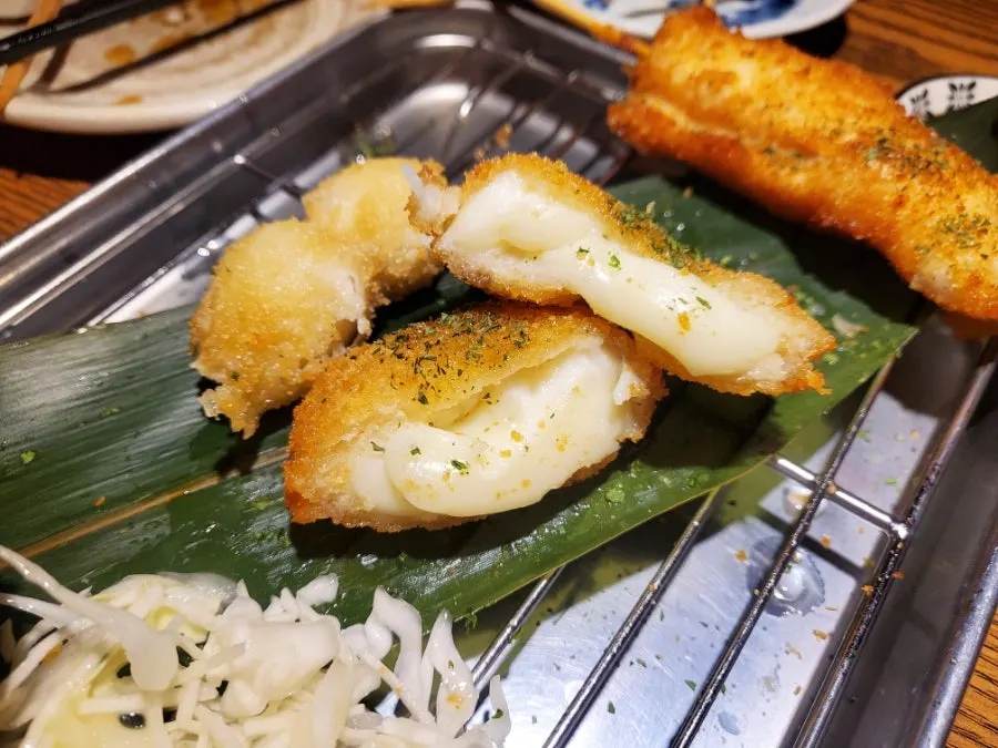 Cross-section of cheese kushikatsu with stretchy cheese