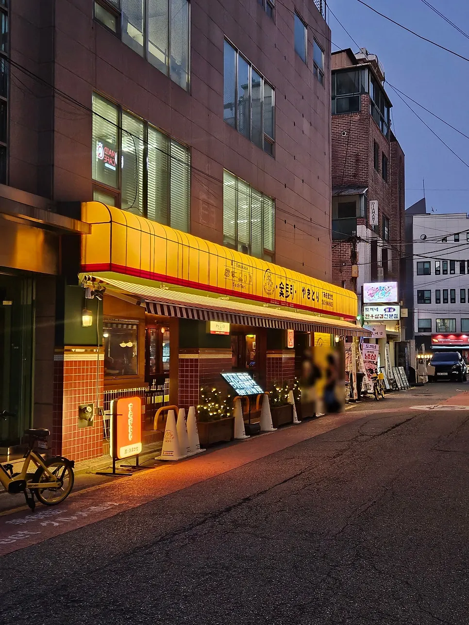 Exterior of Soottori Hongdae Hapjeong with eye-catching yellow lighting