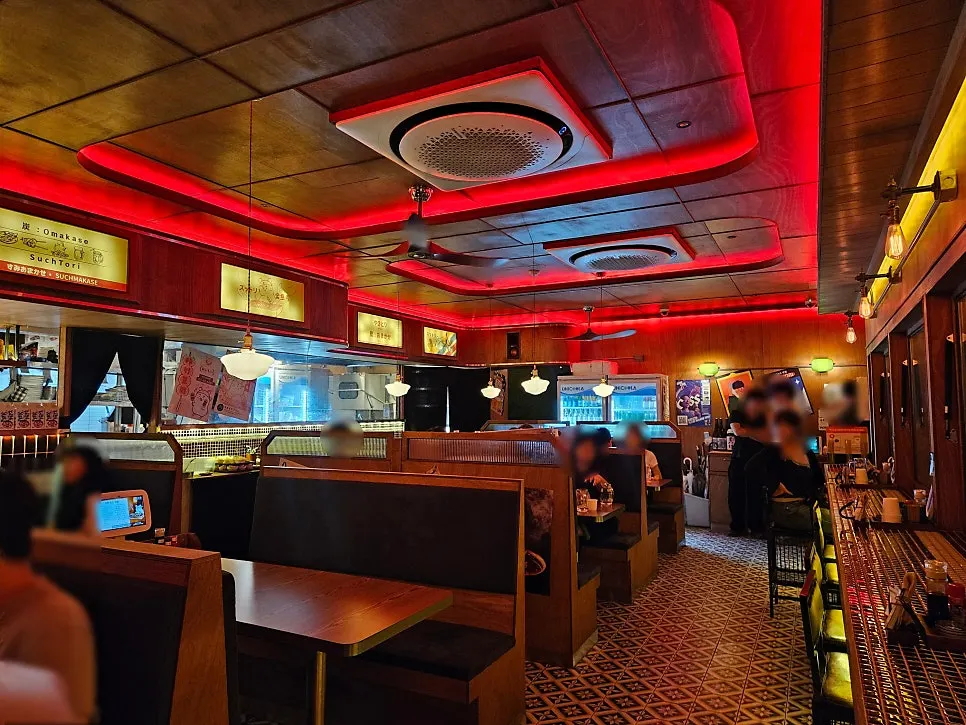 Soottori's interior with wide chairs and red lighting