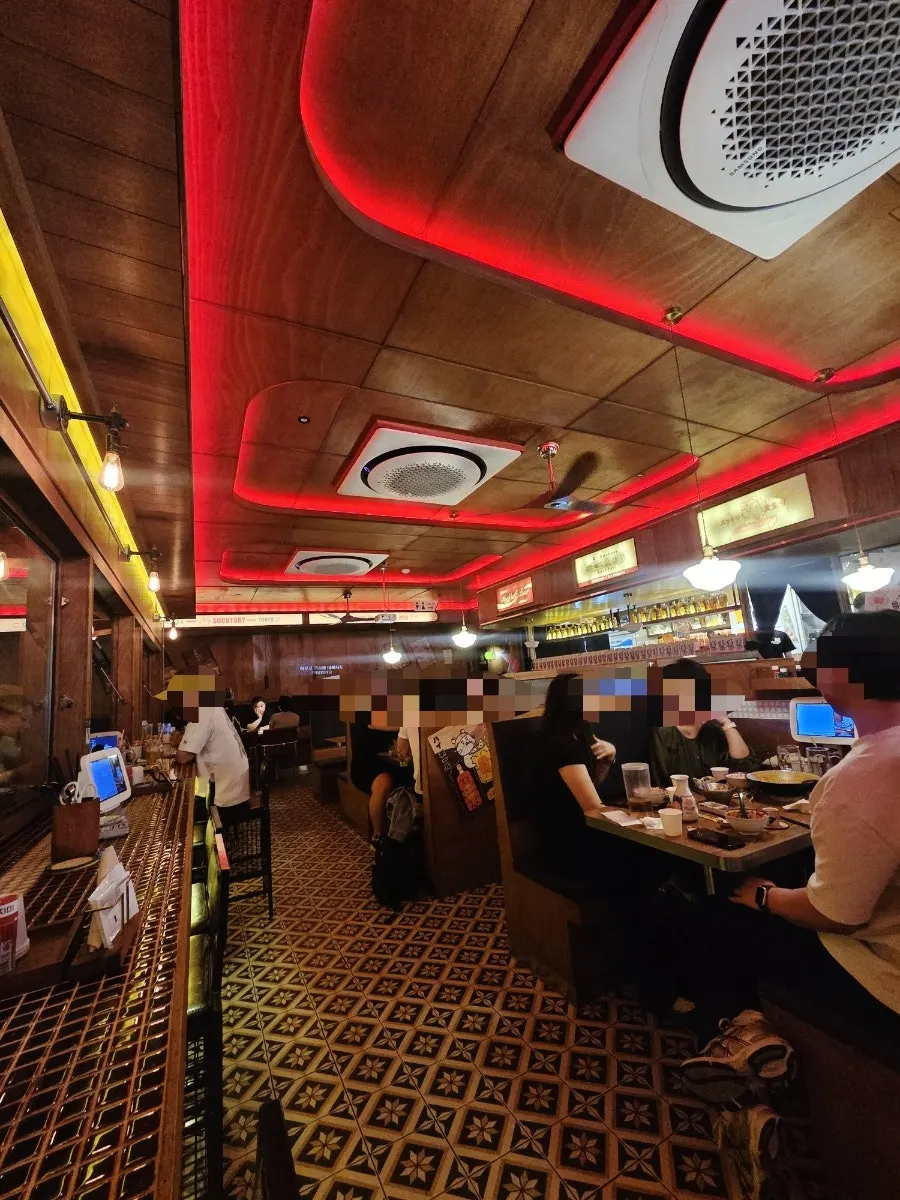 Interior view of Soottori with wood tones and red lighting