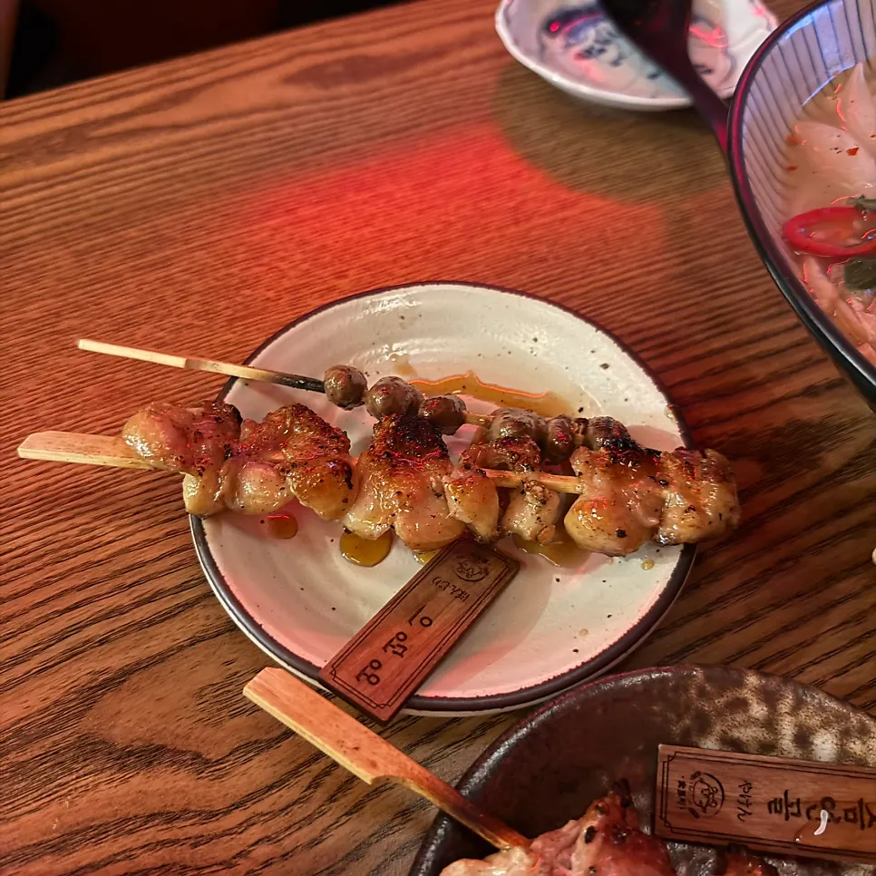 Close-up of charcoal-grilled chicken skewers