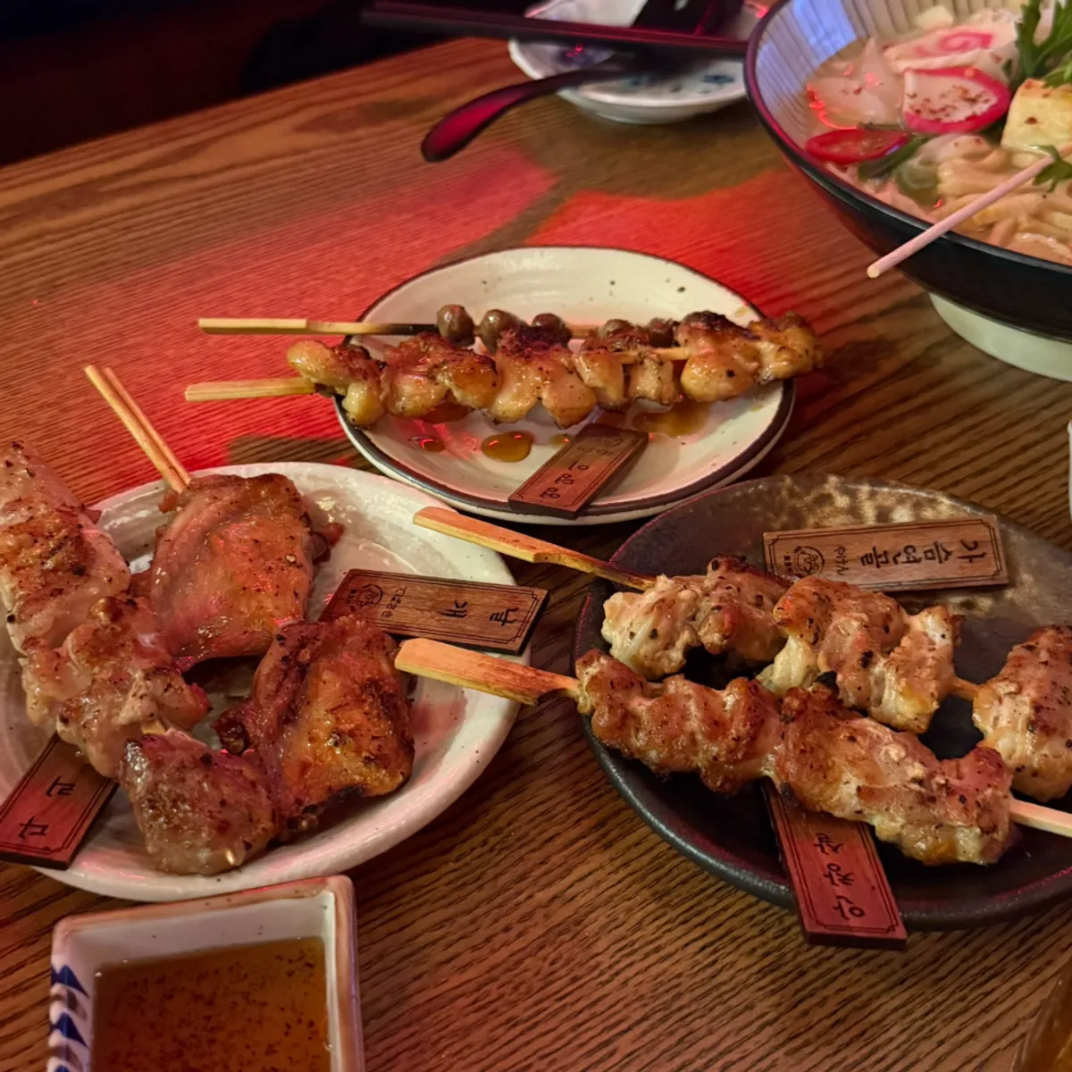Table spread of iced draft beer and yakitori