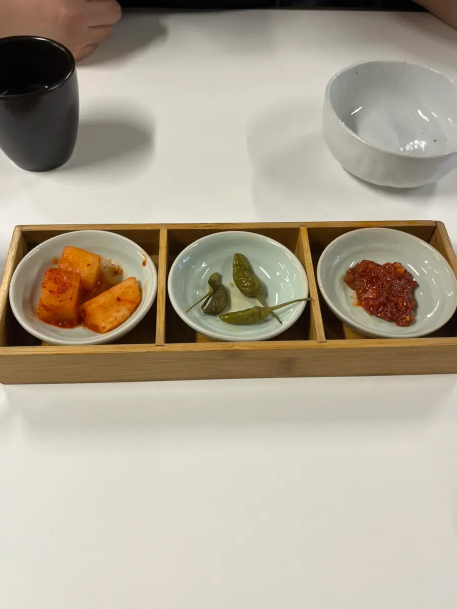 Basic side dishes: kkakdugi, fresh chili peppers, and squid jeotgal