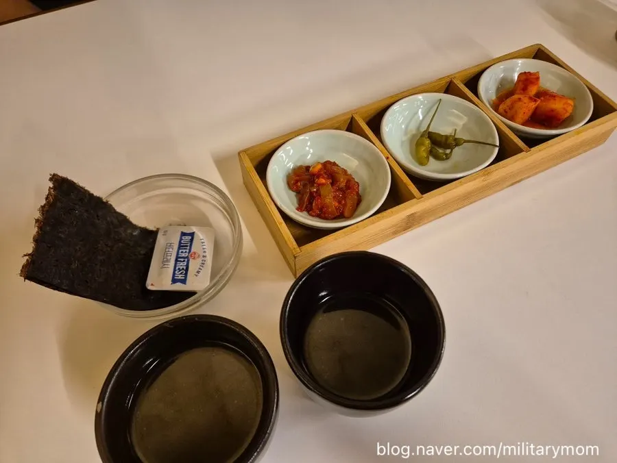 Table setting with galbi pot rice and pollack roe butter pot rice at Sorori