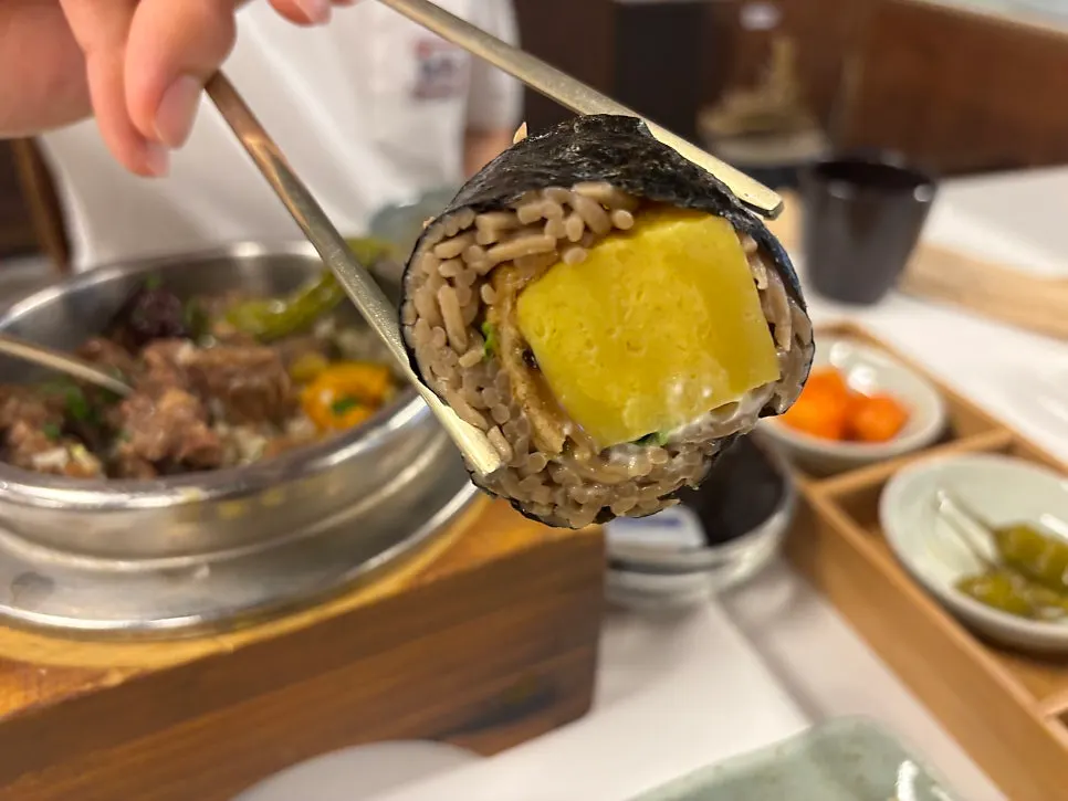 Cross-section of buckwheat gimbap showing buckwheat noodles and rolled omelet