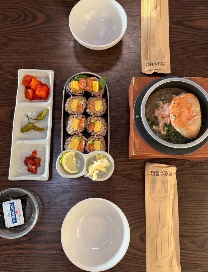 Table set with crab sotbap and raw salmon gimbap